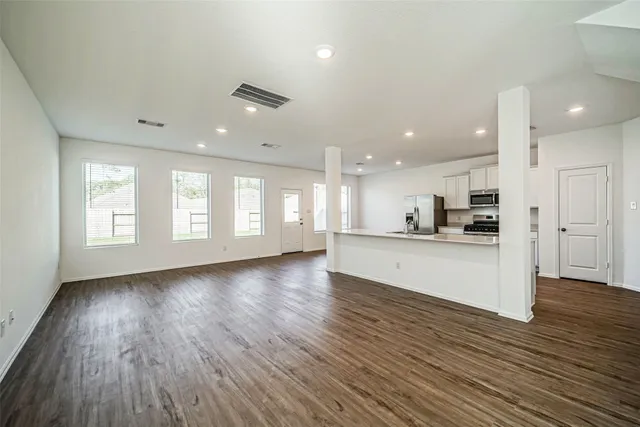 a view of kitchen with cabinets and wooden floor