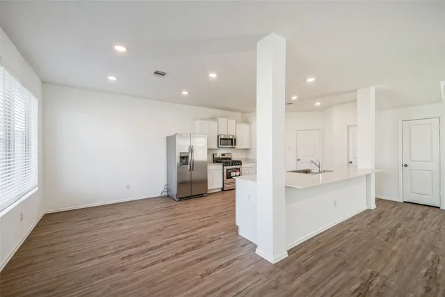 a view of kitchen with wooden floor