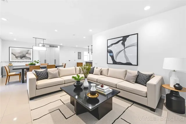 a living room with furniture and a painting on the wall