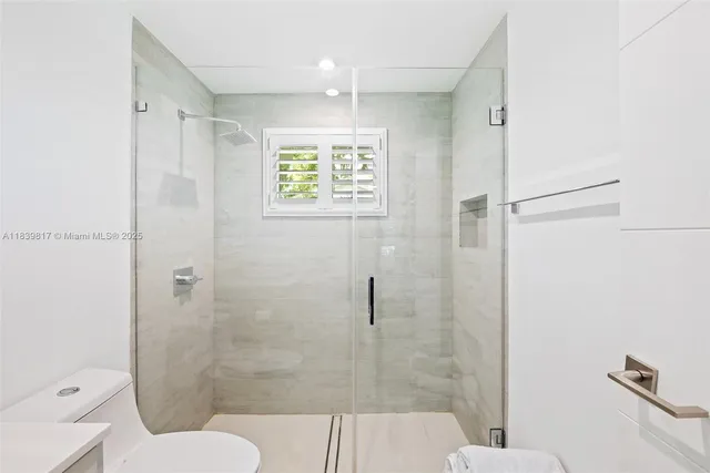 a bathroom with a shower and a toilet