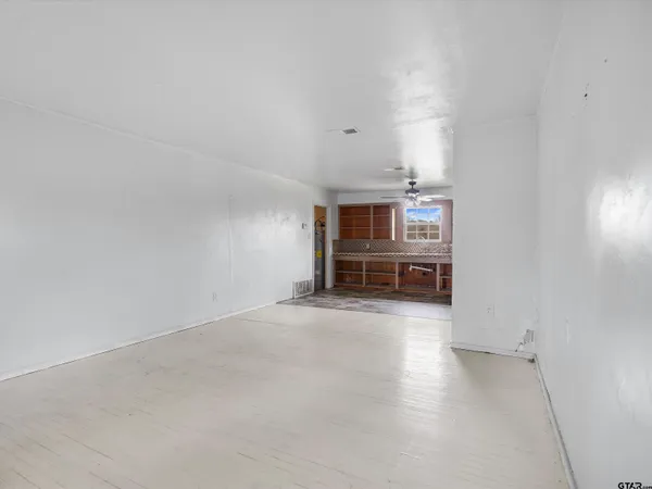 a view of an empty room with a window