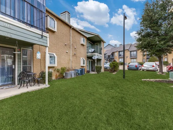 a front view of a building with a garden