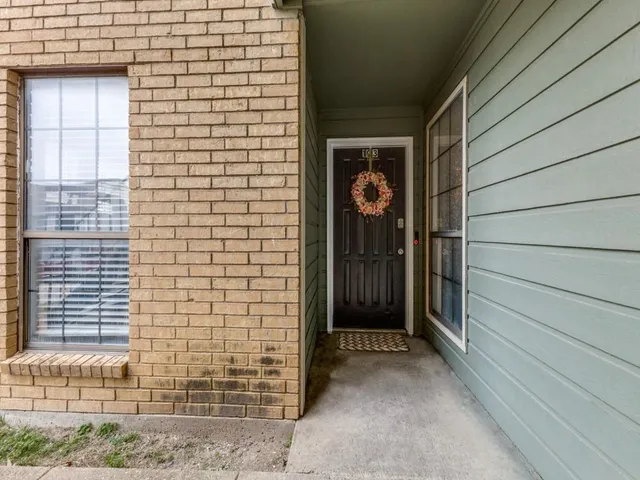 a view of a door and brick wall