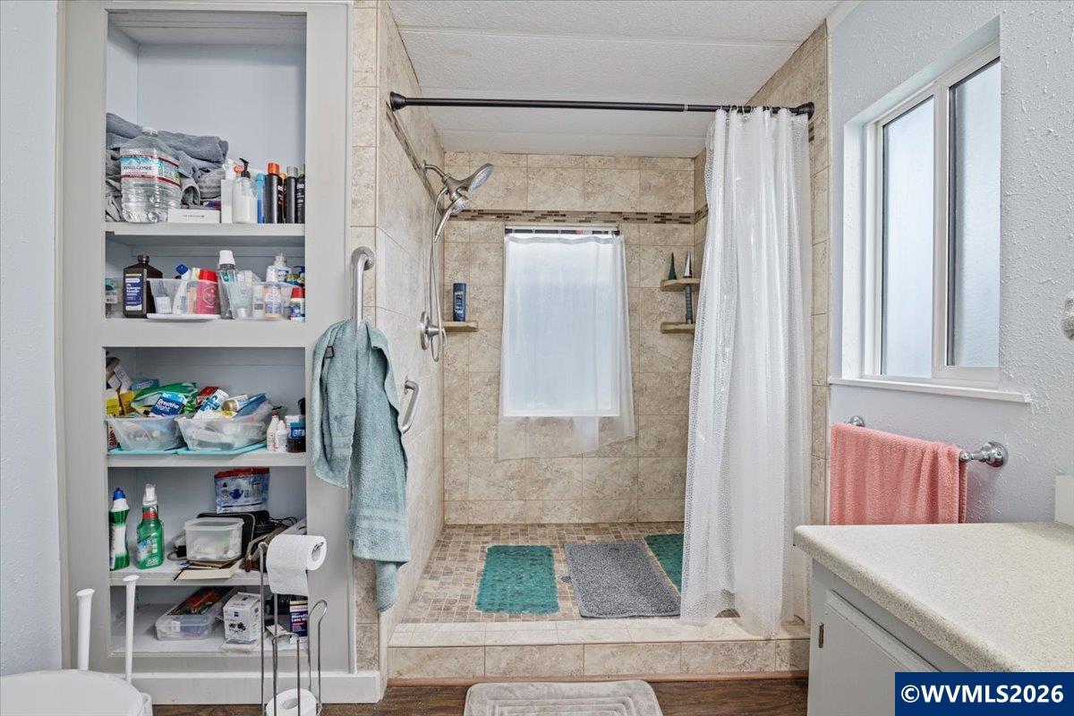 5422 Portland Road Northeast, Unit 123 Salem, OR 97305 - Photo 22 of 23 a bathroom with a bathtub and a shower