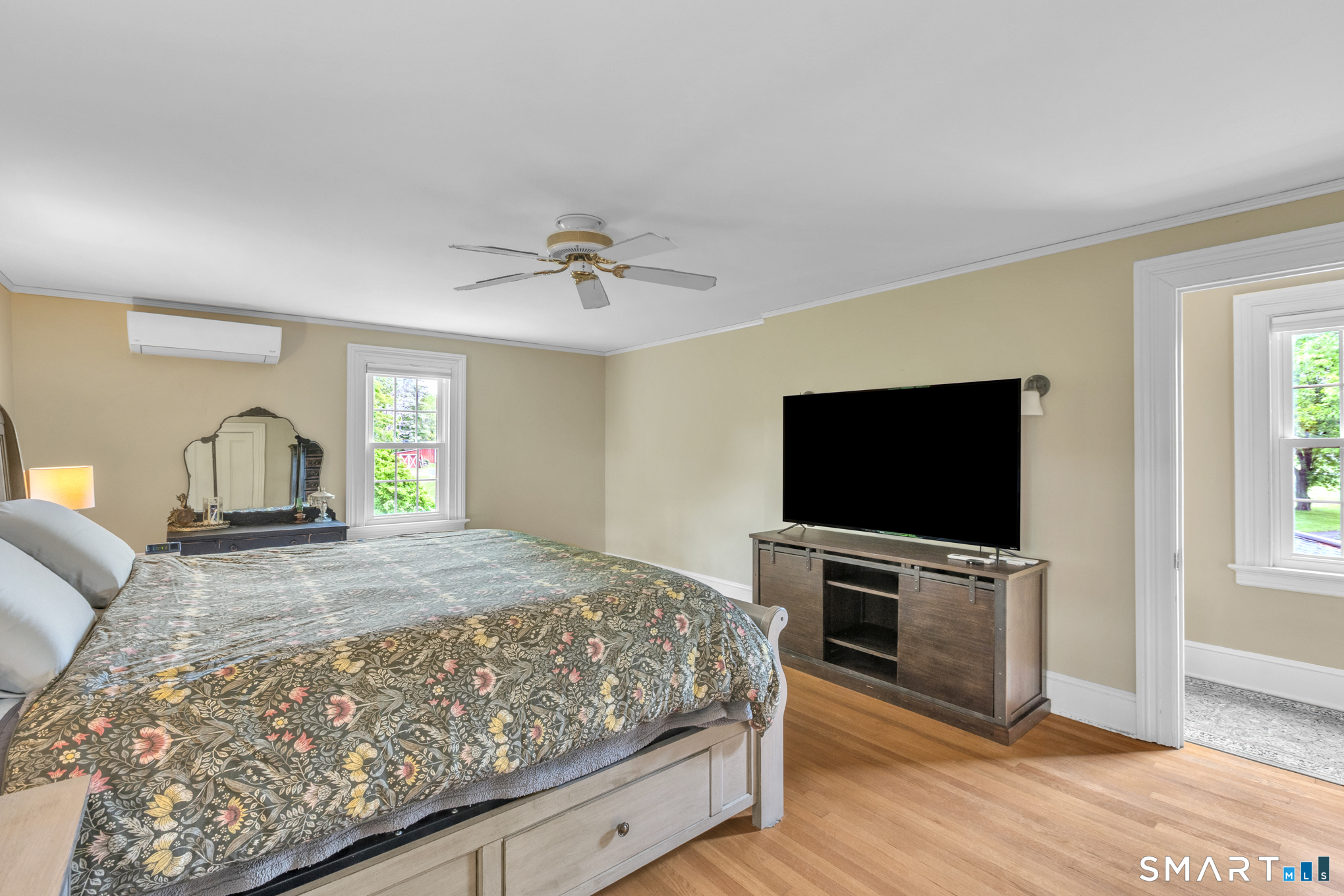 808 Branch Road Suffield, CT 06078 - Photo 22 of 40 a bedroom with a bed and a flat screen tv