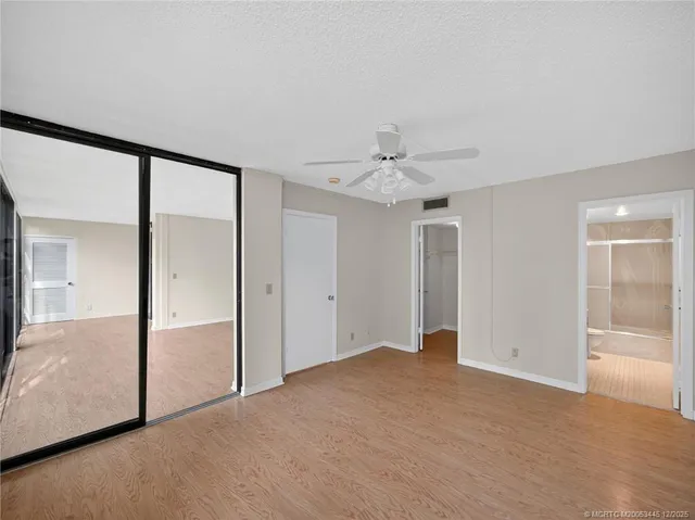 an empty room with fan and entrance