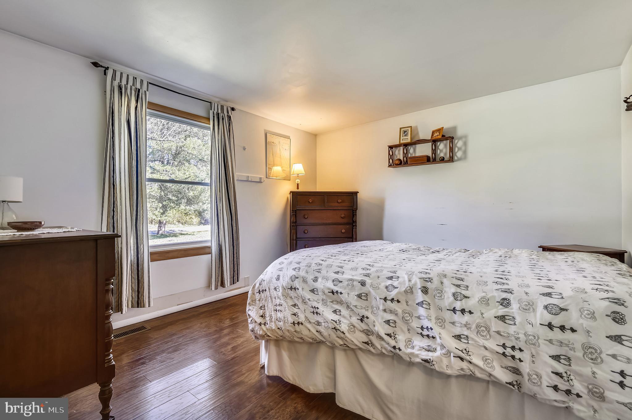 658 New Bridge Road Rising Sun, MD 21911 - Photo 21 of 35 a bedroom with a bed and wooden floor