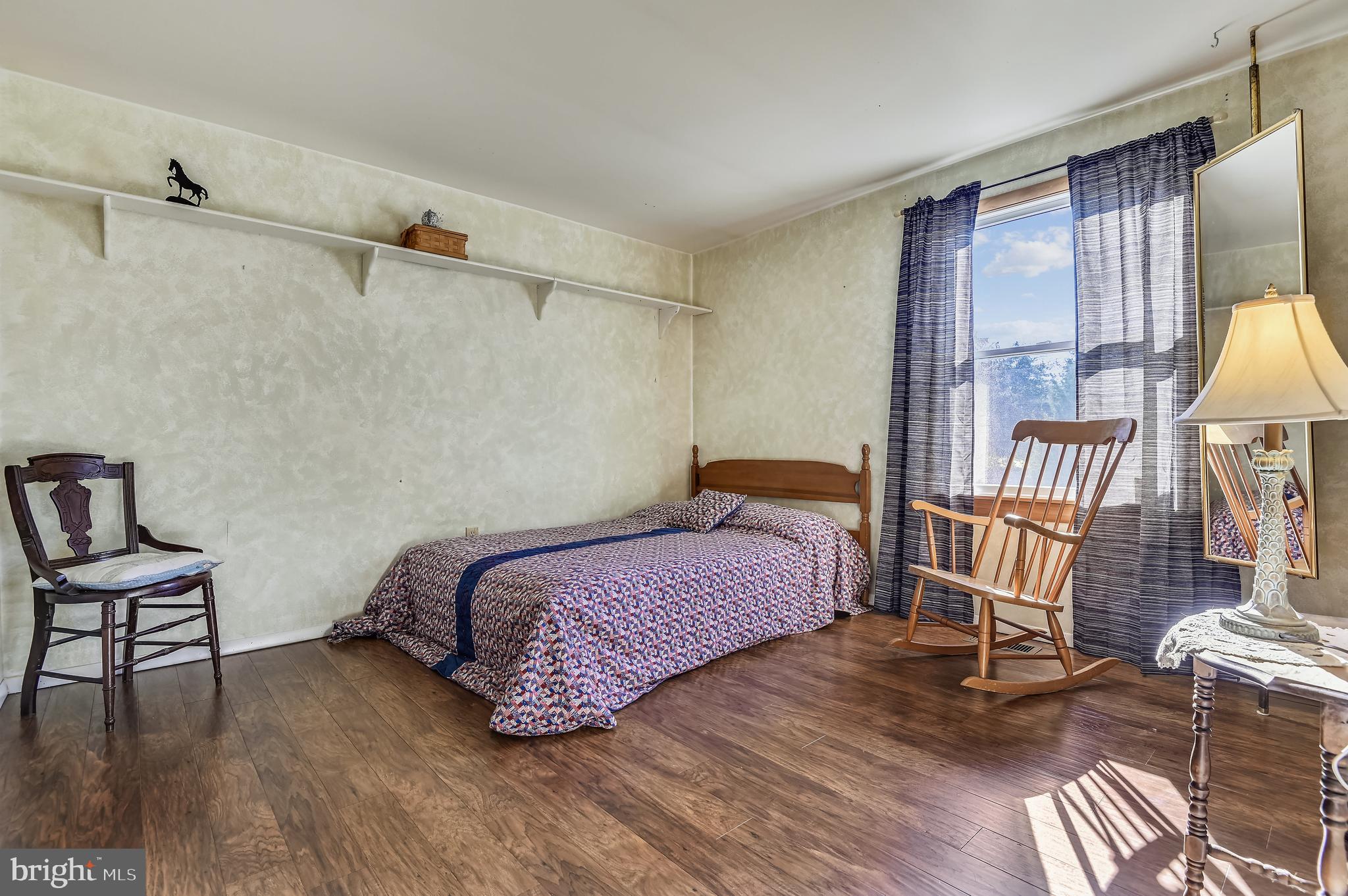 658 New Bridge Road Rising Sun, MD 21911 - Photo 23 of 35 a bedroom with a bed and a chandelier
