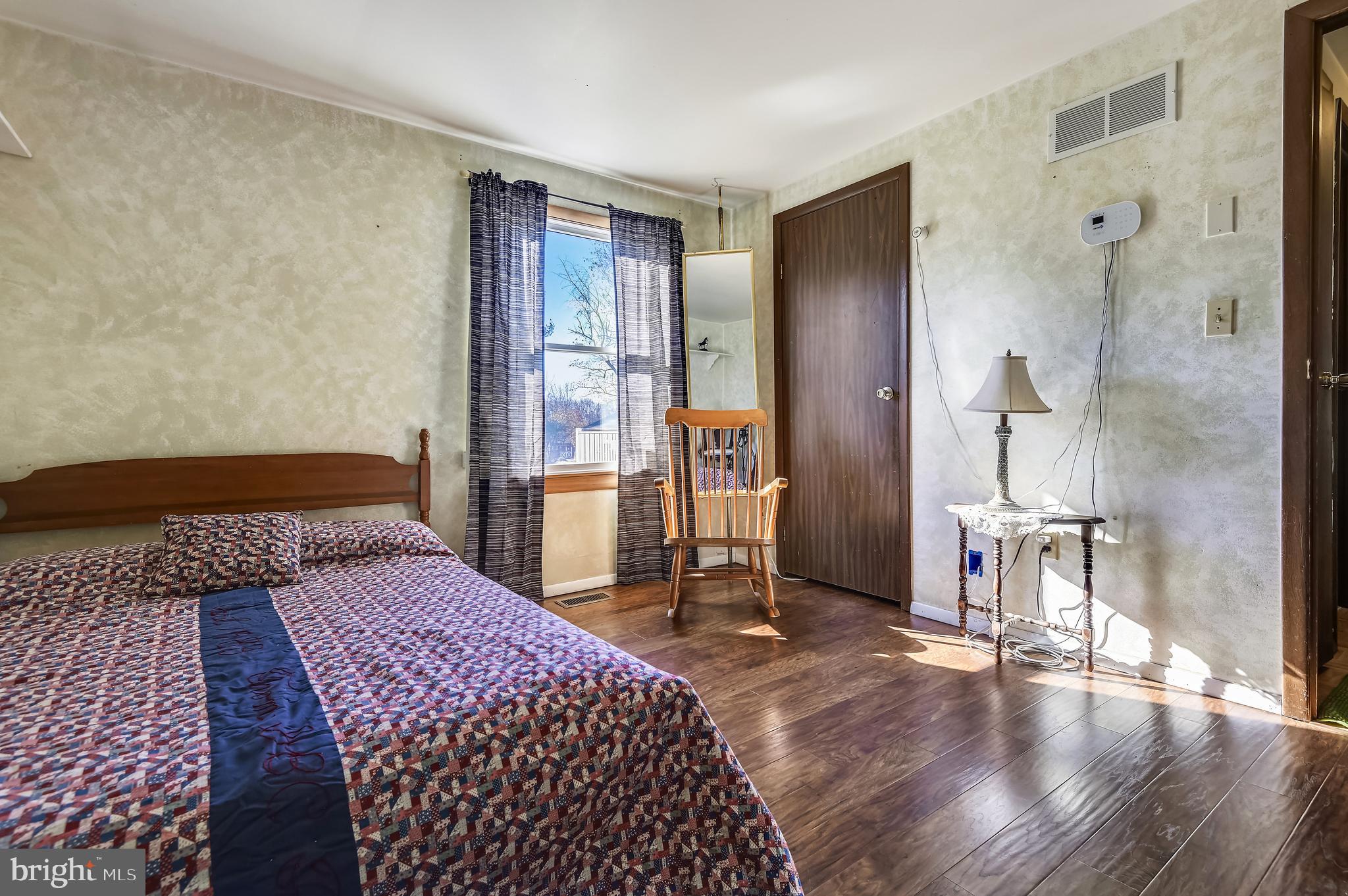 658 New Bridge Road Rising Sun, MD 21911 - Photo 24 of 35 a bedroom with a bed and a table with wooden floor