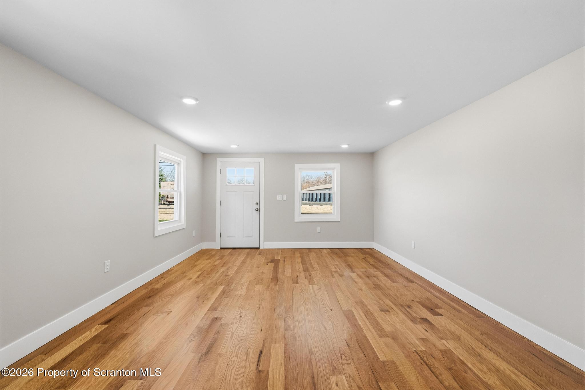 305 Parsonage Street Pittston, PA 18640 - Photo 20 of 42 a view of an empty room with wooden floor and a window