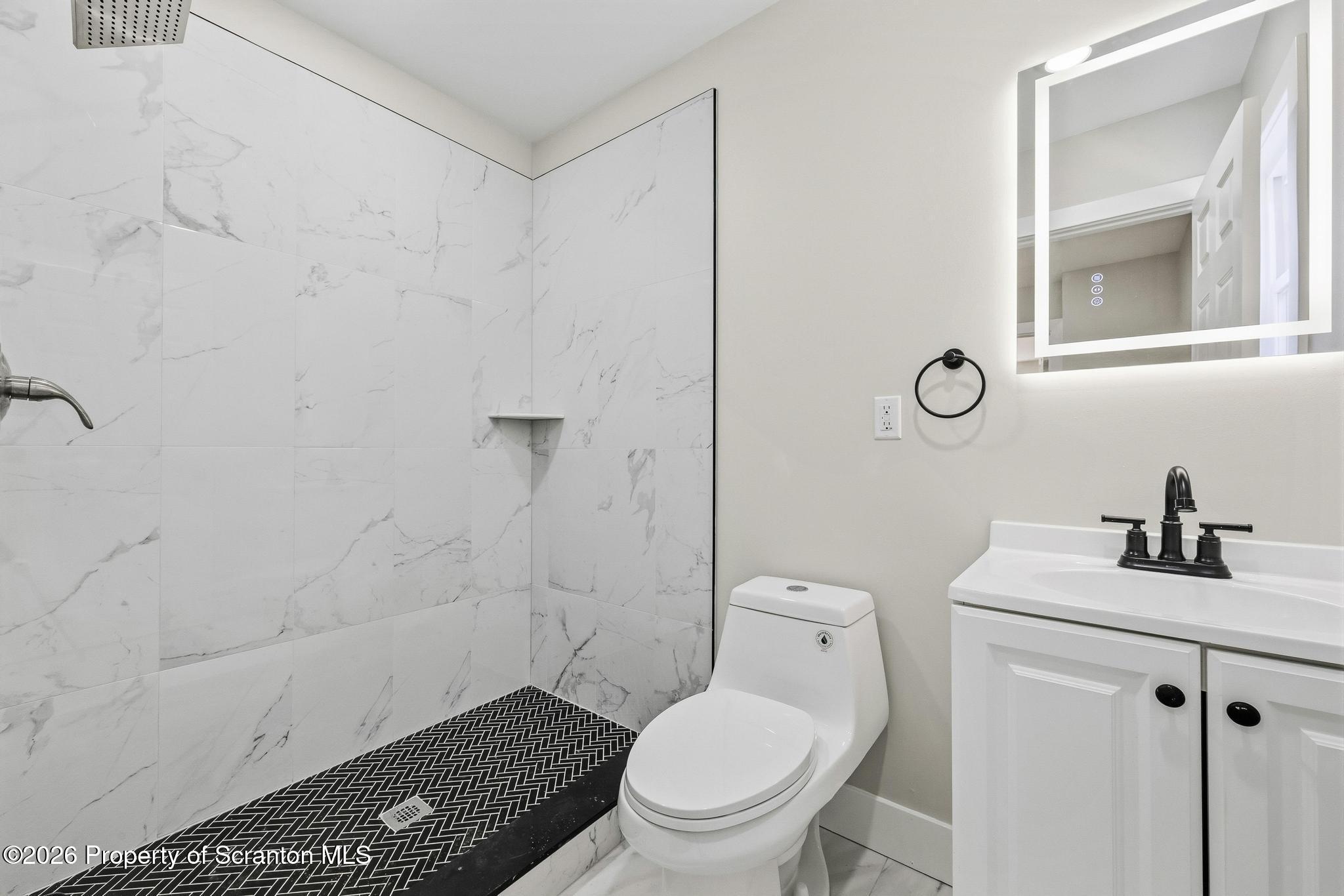 305 Parsonage Street Pittston, PA 18640 - Photo 27 of 42 a bathroom with a toilet a sink and mirror