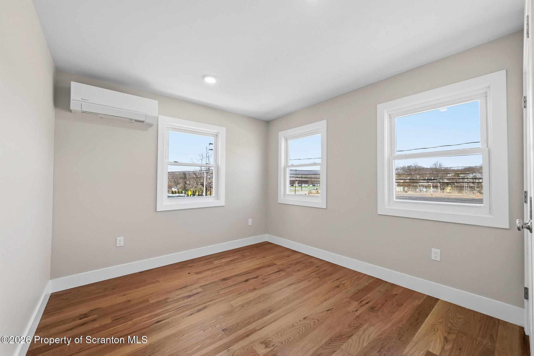 305 Parsonage Street Pittston, PA 18640 - Photo 32 of 42 a view of an empty room with wooden floor and a window