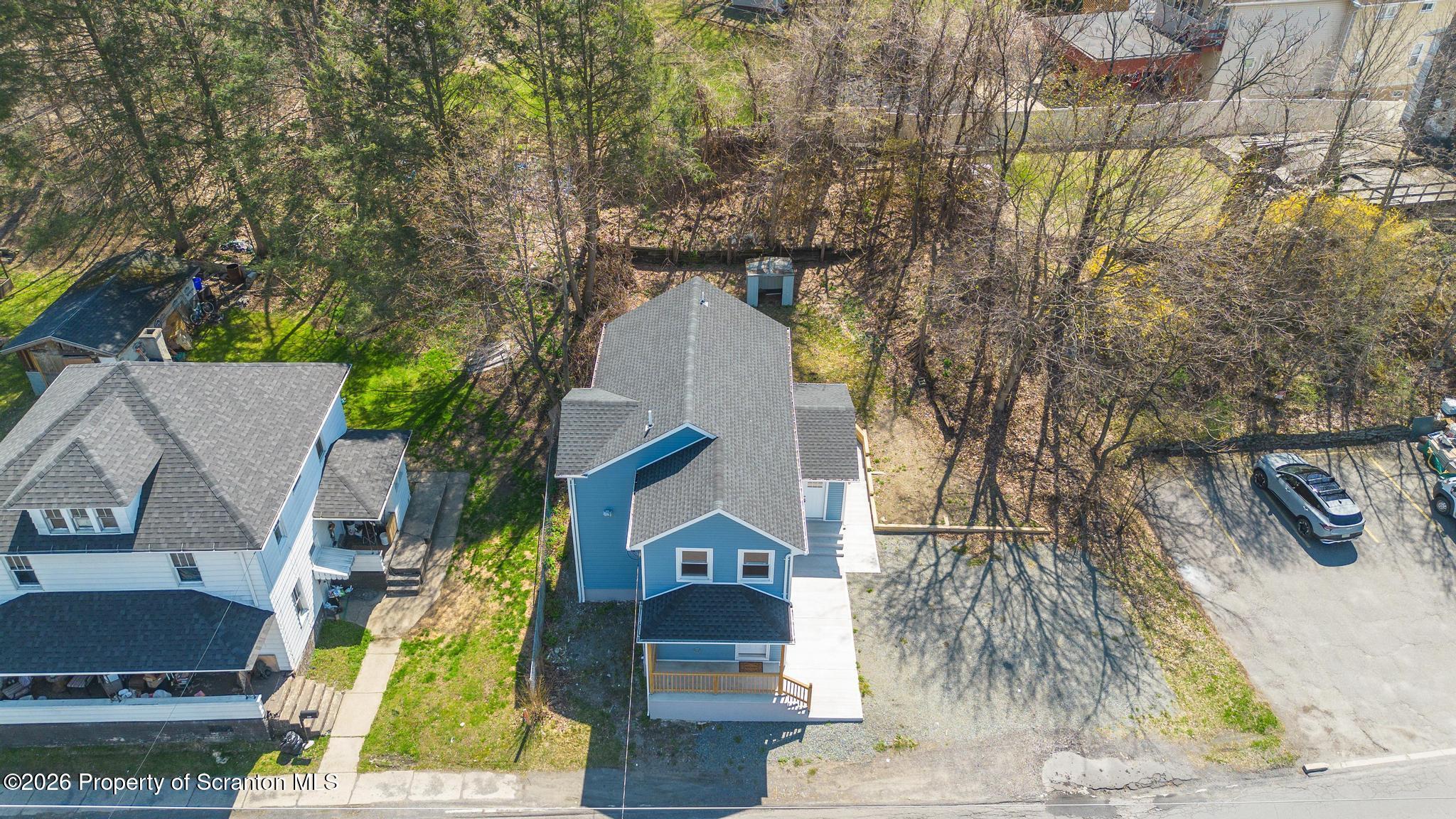 305 Parsonage Street Pittston, PA 18640 - Photo 37 of 42 a front view of a house with a yard and garage