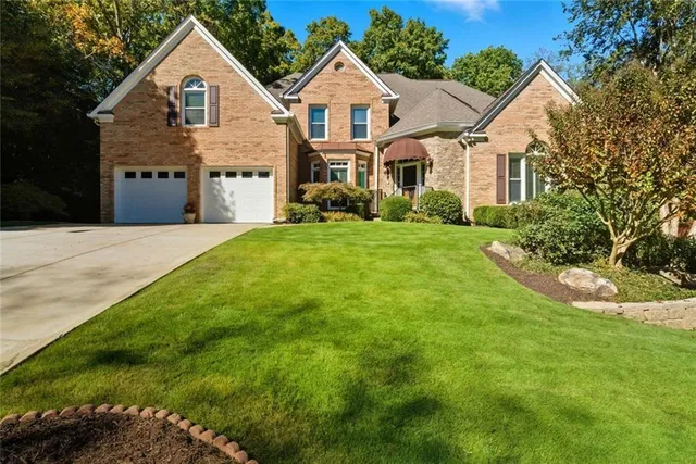 a front view of a house with a yard and garage