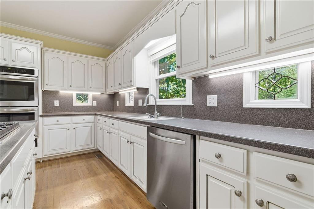 1401 Downington View Acworth, GA 30101 - Photo 20 of 57 a kitchen with granite countertop white cabinets white stainless steel appliances and sink