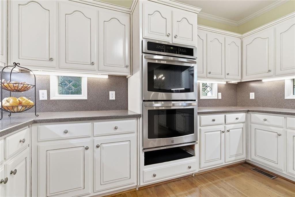 1401 Downington View Acworth, GA 30101 - Photo 21 of 57 a kitchen with granite countertop white cabinets and appliances