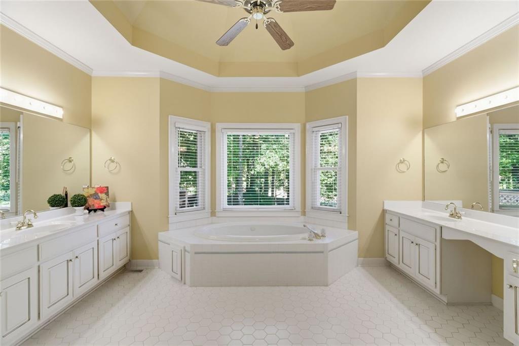 1401 Downington View Acworth, GA 30101 - Photo 23 of 57 a spacious bathroom with a double vanity sink large mirror and a bathtub