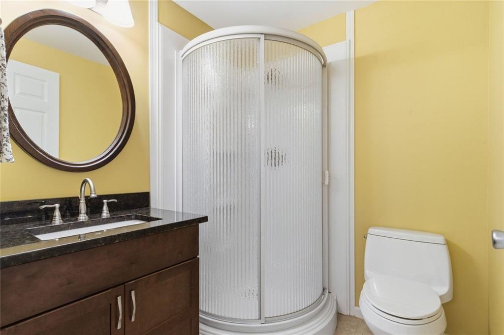 1401 Downington View Acworth, GA 30101 - Photo 39 of 57 a bathroom with a toilet a sink and a mirror