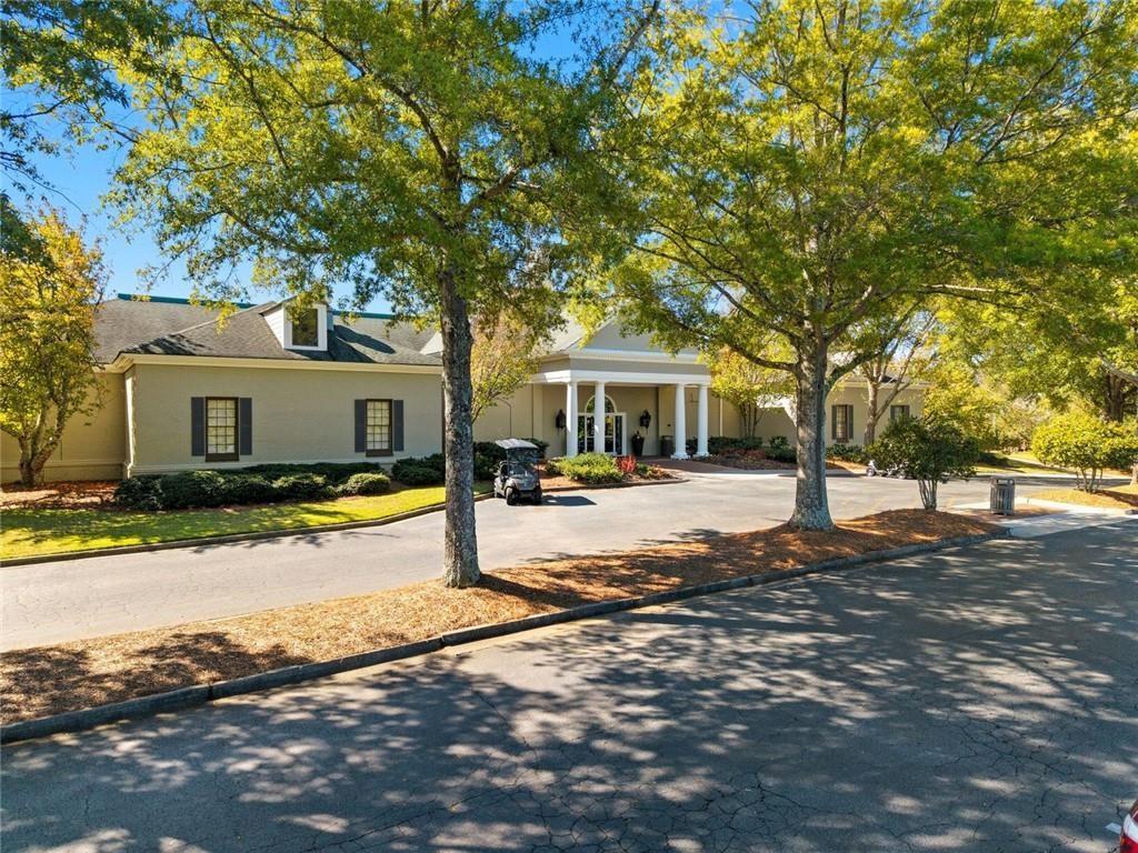1401 Downington View Acworth, GA 30101 - Photo 51 of 57 a view of a white house with a large tree and yard