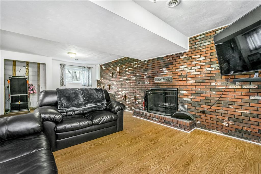 190 McChain Road Finleyville, PA 15332 - Photo 18 of 25 Downstairs, the huge game room features a wood-burning fireplace and expansive brick accent wall.