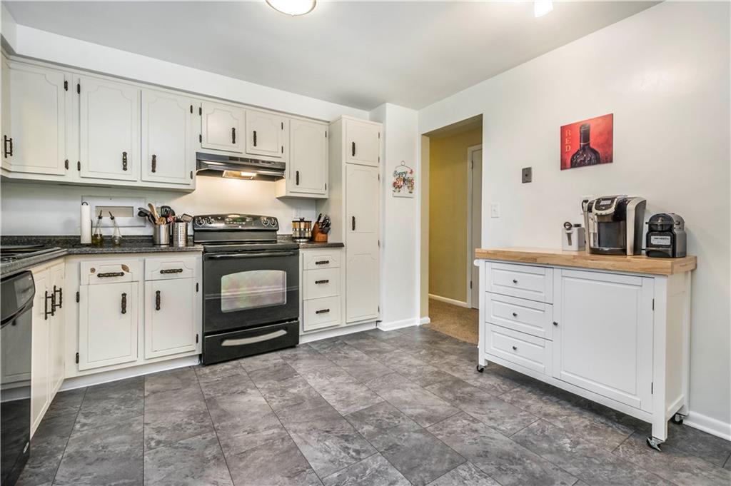 190 McChain Road Finleyville, PA 15332 - Photo 8 of 25 This spacious kitchen features black appliances that pop off the white cabinets & new floors!