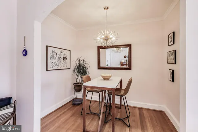 a view of a dining room with furniture wooden floor and a chandelier