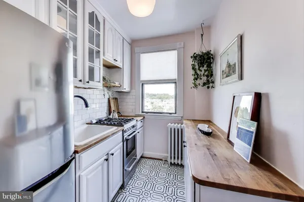a kitchen with stainless steel appliances granite countertop a stove a sink dishwasher and a refrigerator