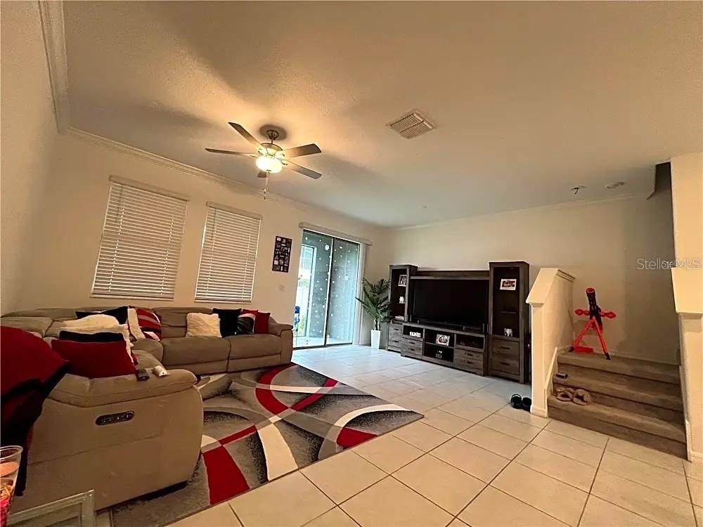 31751 Blue Passing Loop Wesley Chapel, FL 33545 - Photo 7 of 18 a living room with furniture and a flat screen tv