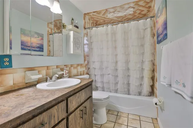 a view of a room with a lot of flower plants and wooden fence