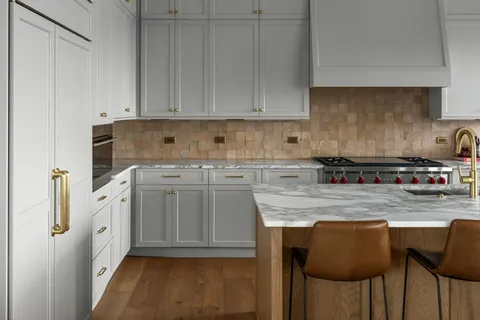 a kitchen with stainless steel appliances granite countertop a stove a sink and cabinets