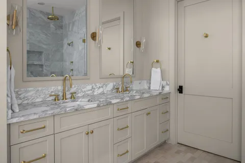 a bathroom with a granite countertop sink and a mirror