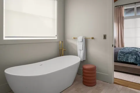 a bathroom with a bathtub and a window