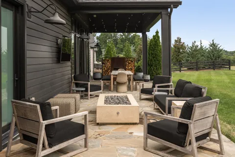 a view of a patio with a dining table and chairs