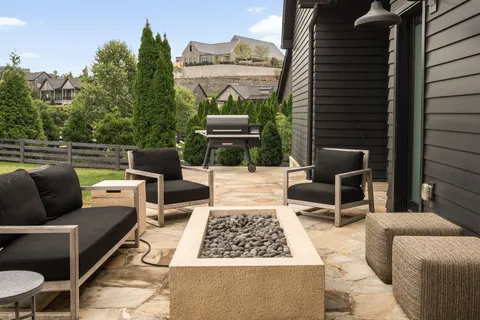 a balcony with couch and chairs