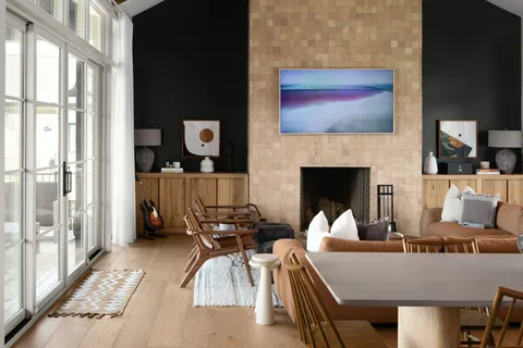 a living room with furniture fireplace and a large window