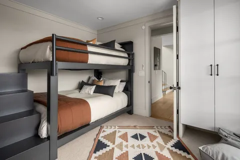 a bathroom with a granite countertop sink a toilet and mirror