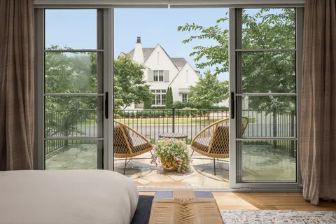 a view of a chair and tables in the balcony