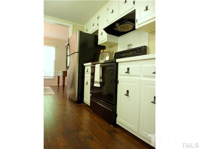 3155 Morningside Drive Raleigh, NC 27607 - Photo 6 of 9 a kitchen with stainless steel appliances wooden floor