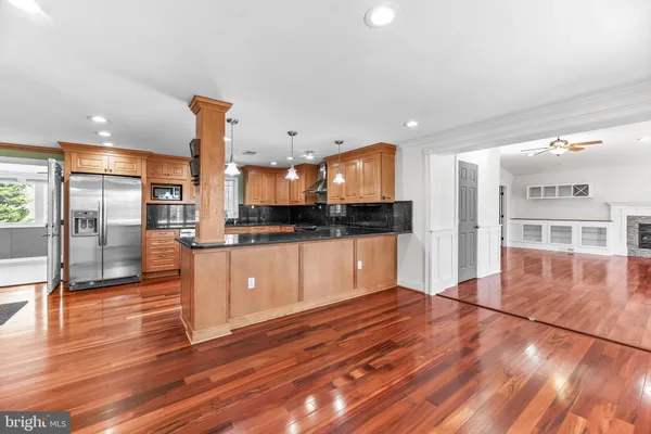 a large kitchen with stainless steel appliances kitchen island a large counter top and a stove