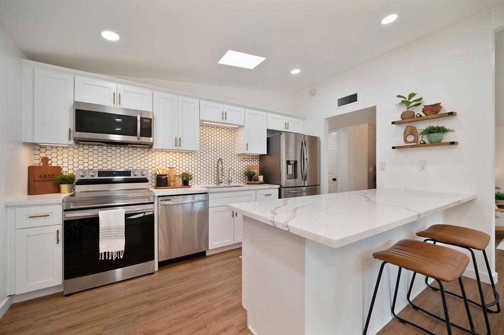 4812 Packard Court Carmichael, CA 95608 - Photo 11 of 39 a kitchen with stainless steel appliances a stove a sink a microwave a refrigerator and cabinets