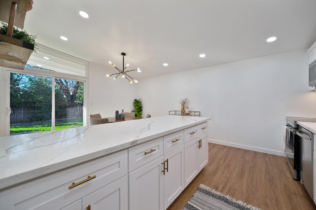 4812 Packard Court Carmichael, CA 95608 - Photo 13 of 39 a spacious bathroom with a granite countertop sink and a large mirror