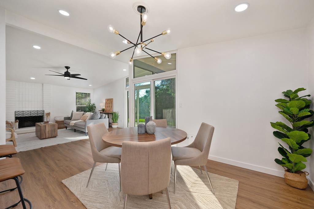 4812 Packard Court Carmichael, CA 95608 - Photo 9 of 39 a dining room with wooden floor a chandelier a glass table and chairs