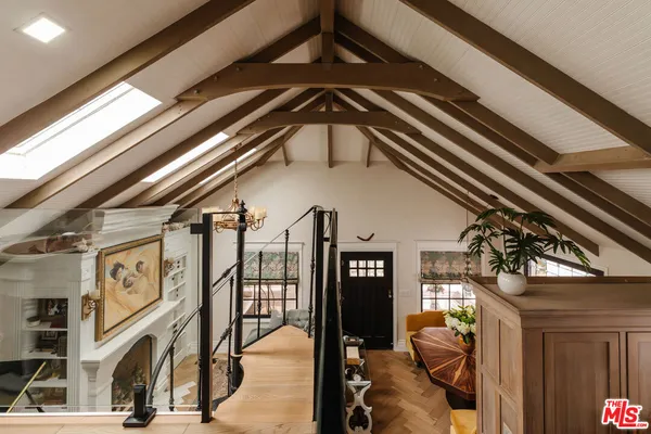 a dining room with furniture and a floor to ceiling window