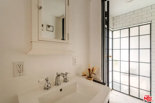 a bedroom with a bed and cabinets