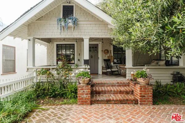 a view of a house with a potted plant