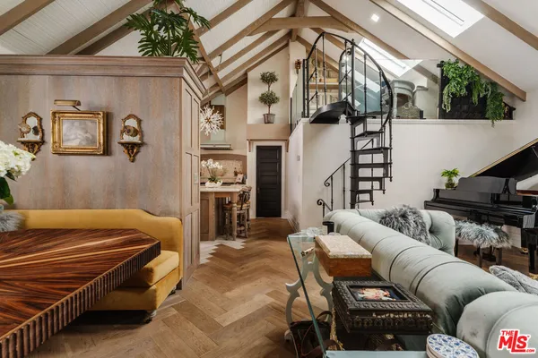 a living room with furniture a couch and wooden floor