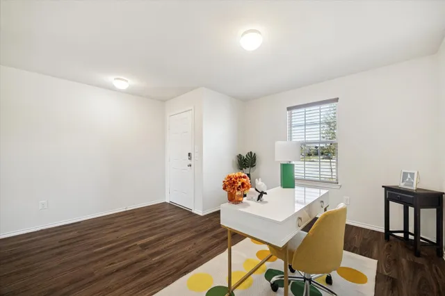 a view of a dining room with furniture and window