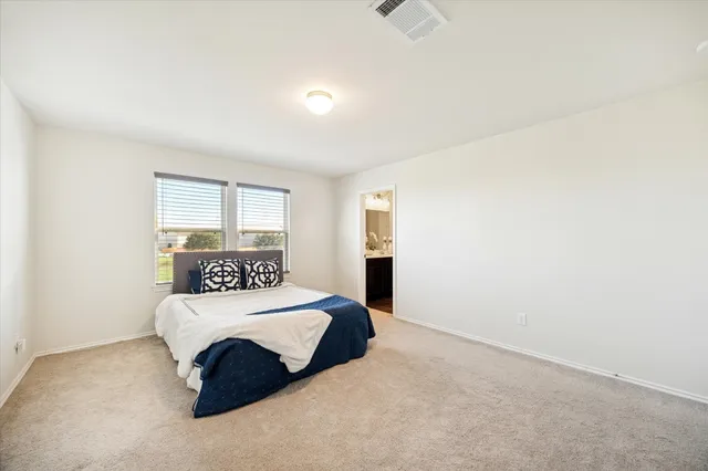 a bedroom with a bed and a night stand