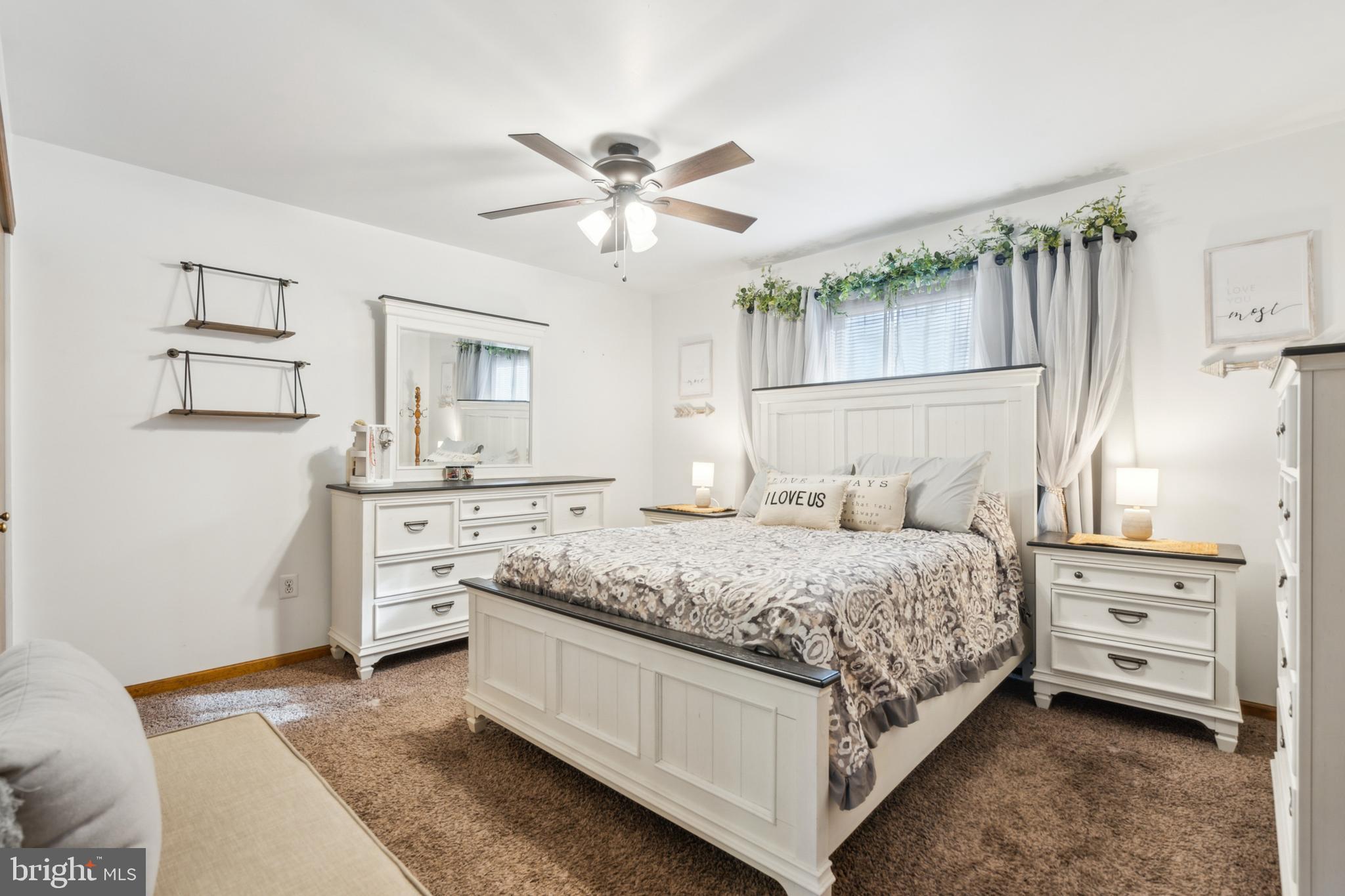 20 Holly Trail Alloway, NJ 08302 - Photo 12 of 26 a bedroom with a bed and a chandelier