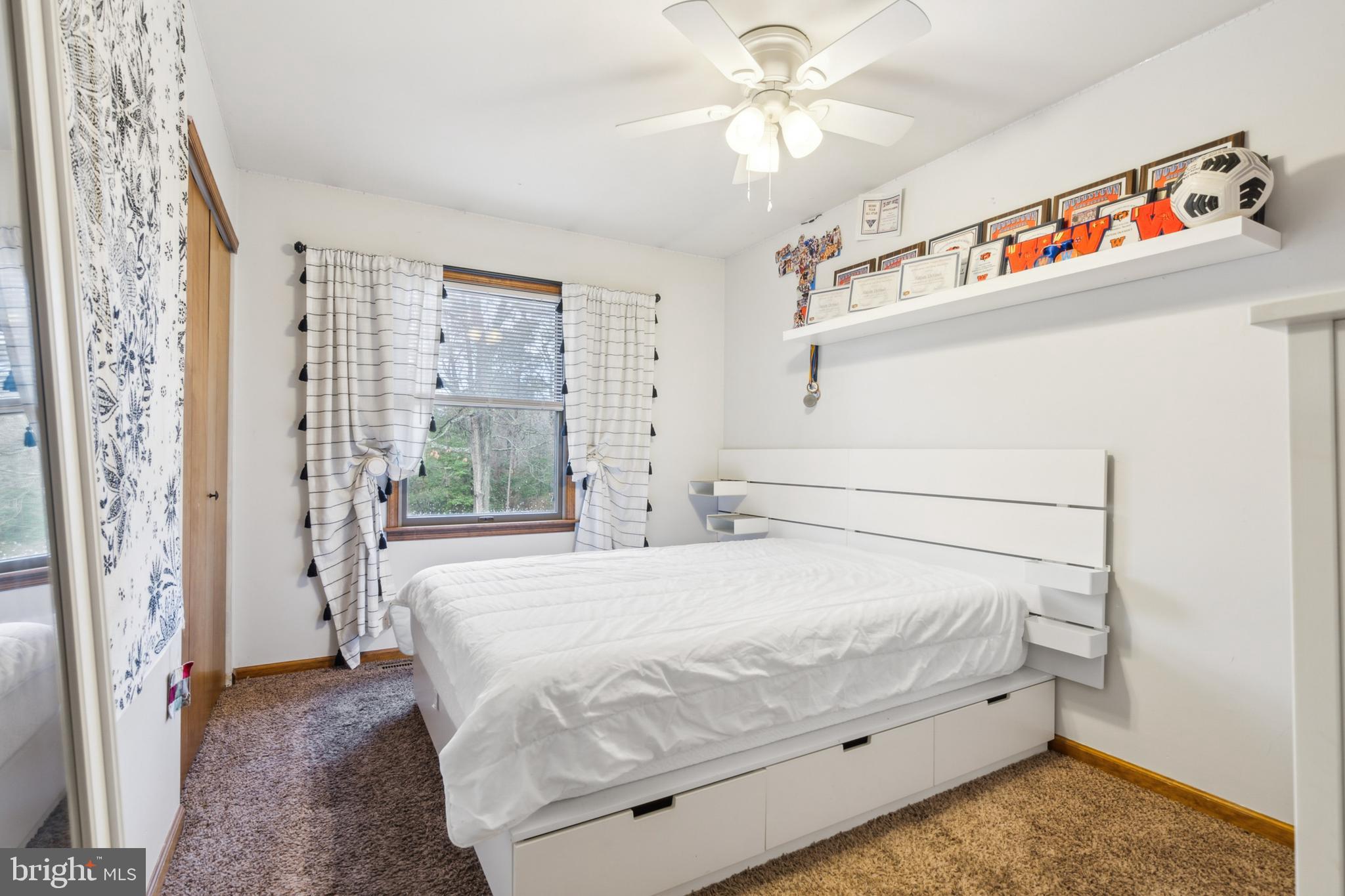 20 Holly Trail Alloway, NJ 08302 - Photo 14 of 26 a bedroom with a bed and a chandelier